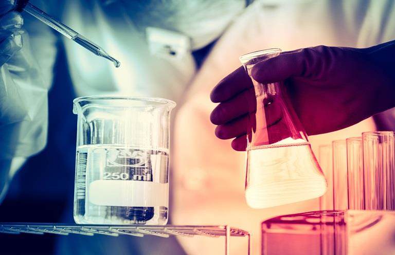 Scientist handling laboratory glassware